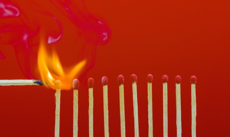 Burning matchsticks setting fire to its neighbors